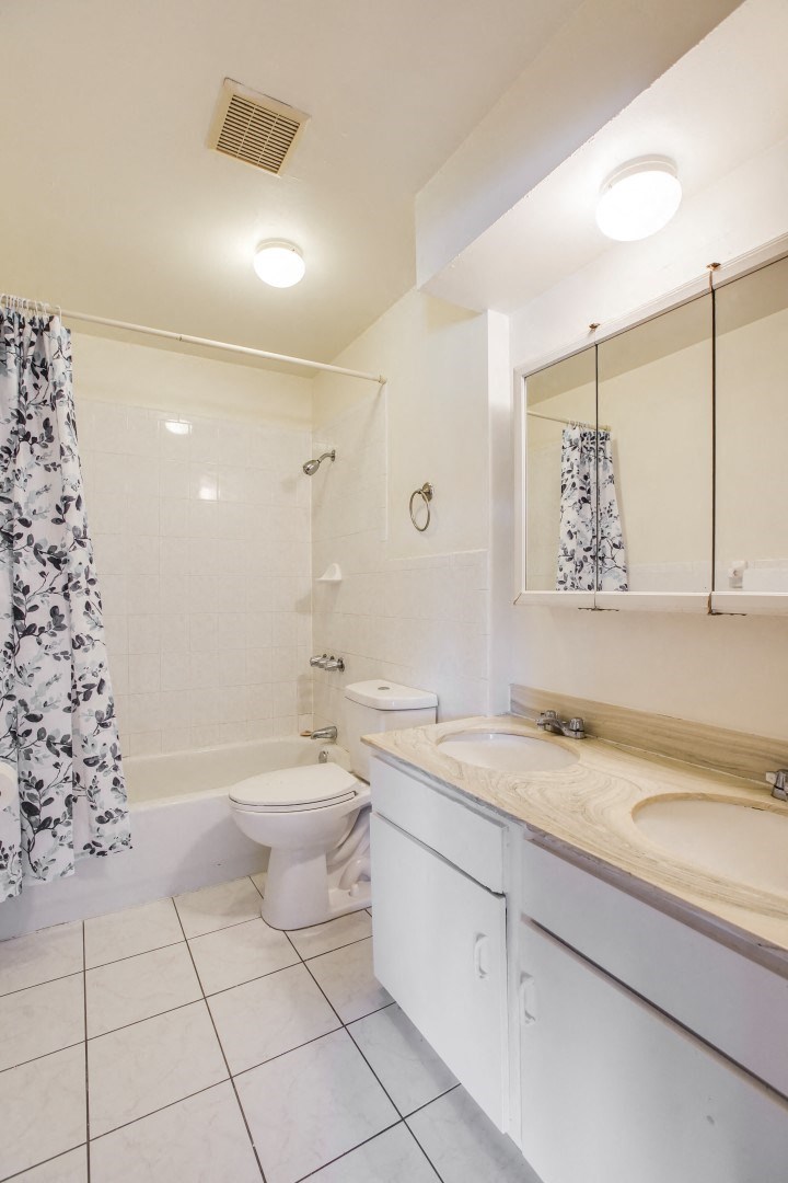 a bathroom with a toilet and a sink and a shower