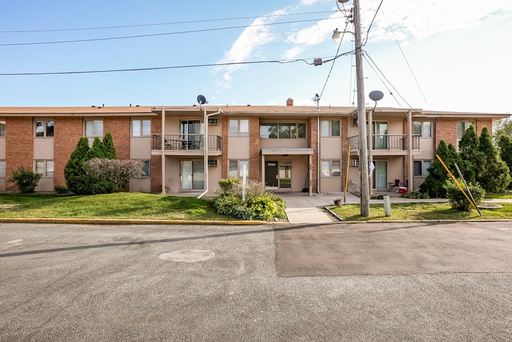 an apartment building with a street in front of it