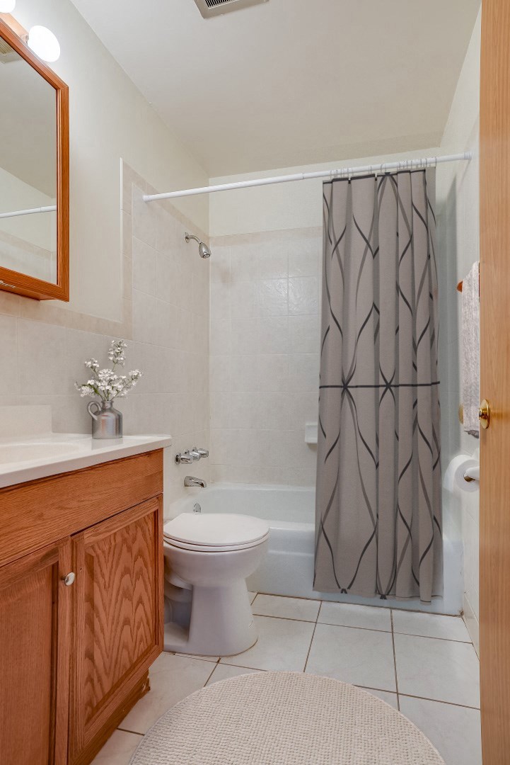 a bathroom with a shower curtain and a toilet