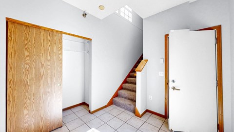 A room with a staircase and two doors.