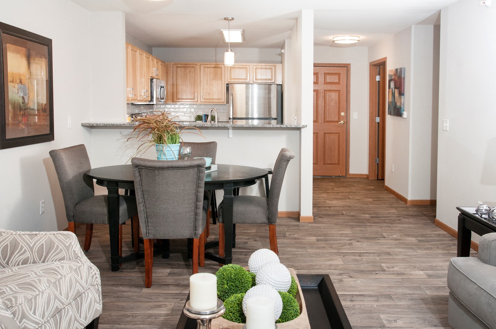 a living room and dining room with a table and chairs and a kitchen