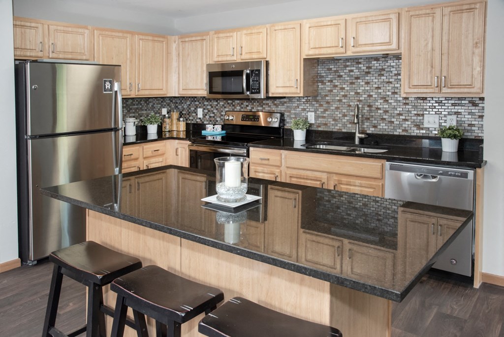 kitchen with island, granite countertop, tile backsplash