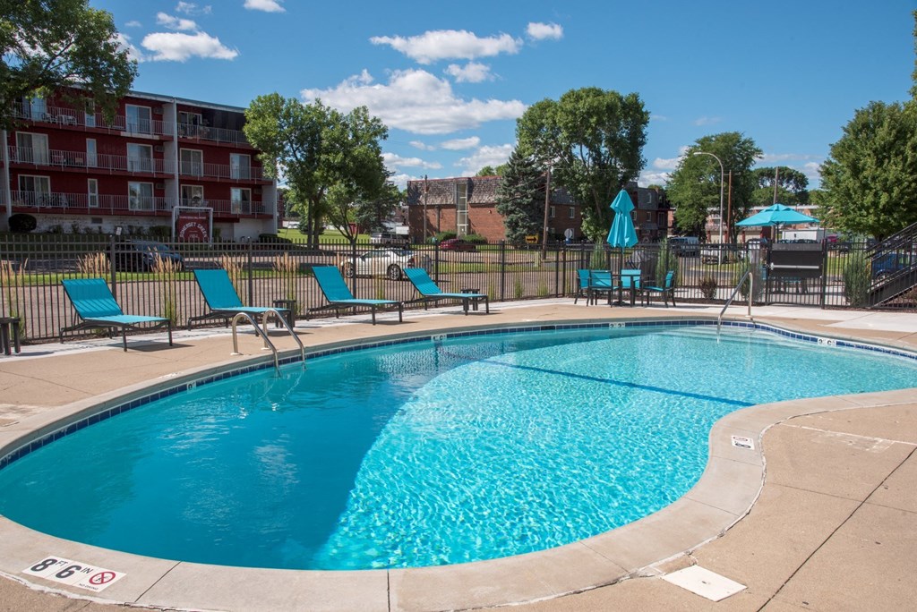 outdoor pool with sundeck and lounge chairs