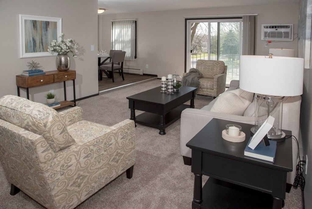one plus den model, living room with view of balcony and dining area