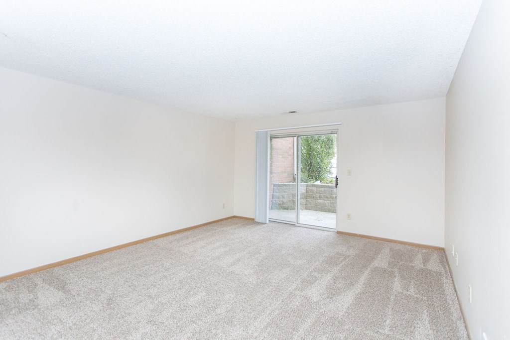 vacant living room with balcony at Cinnamon Ridge Apartments, Minnesota