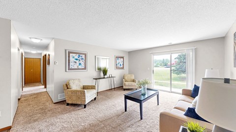 A living room with a couch, chairs, and a coffee table.