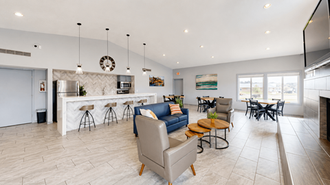 A modern living room with a bar area and a kitchen in the background.