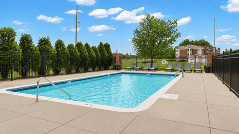 A small pool surrounded by a black fence.