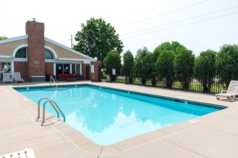 a swimming pool with a building in the background