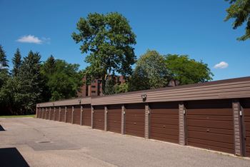 a row of garage doors with trees in the background