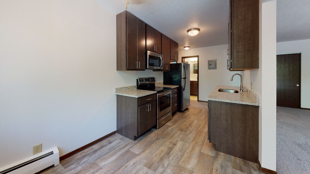 a kitchen with stainless steel appliances and wooden cabinets