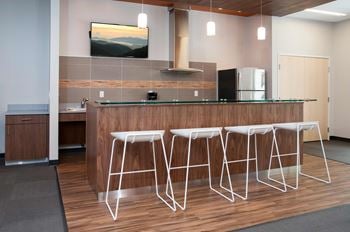 a kitchen with a bar and stools