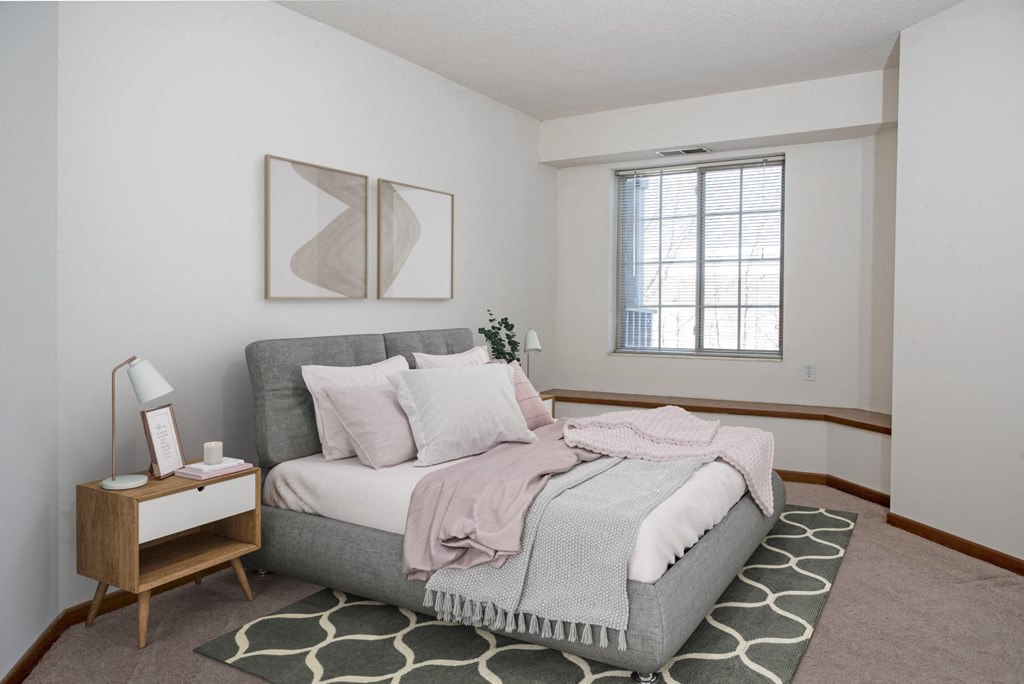 a bedroom with a bed and a rug