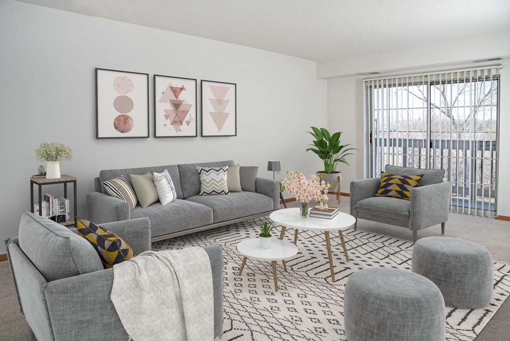 a living room with couches and chairs and a rug