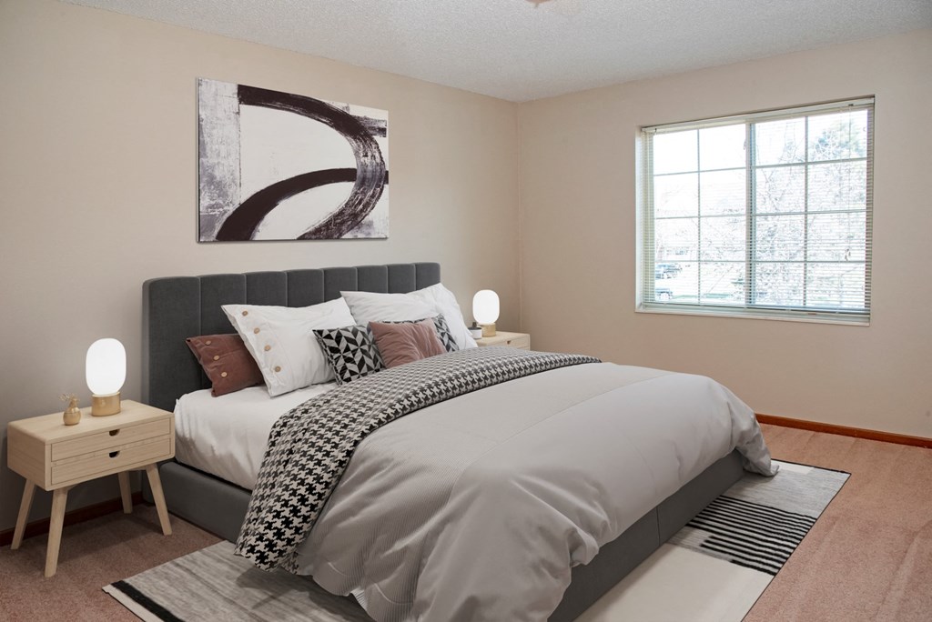 a bedroom with a large bed and a window