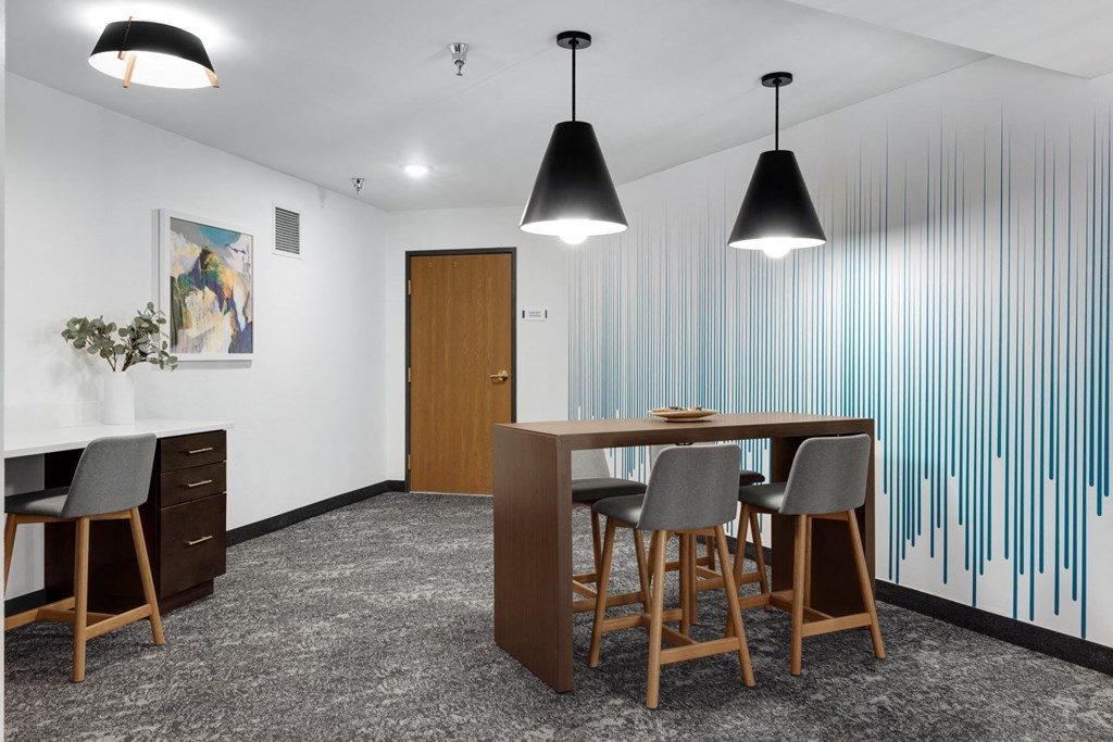 a dining room with a wooden table and chairs