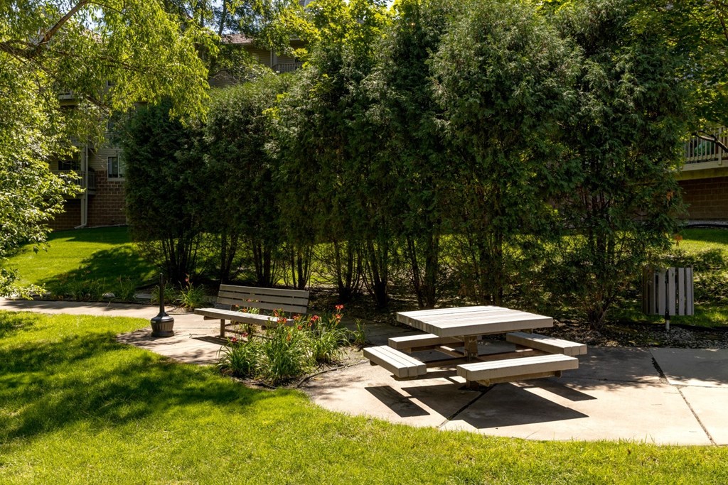 a picnic table and benches in a park