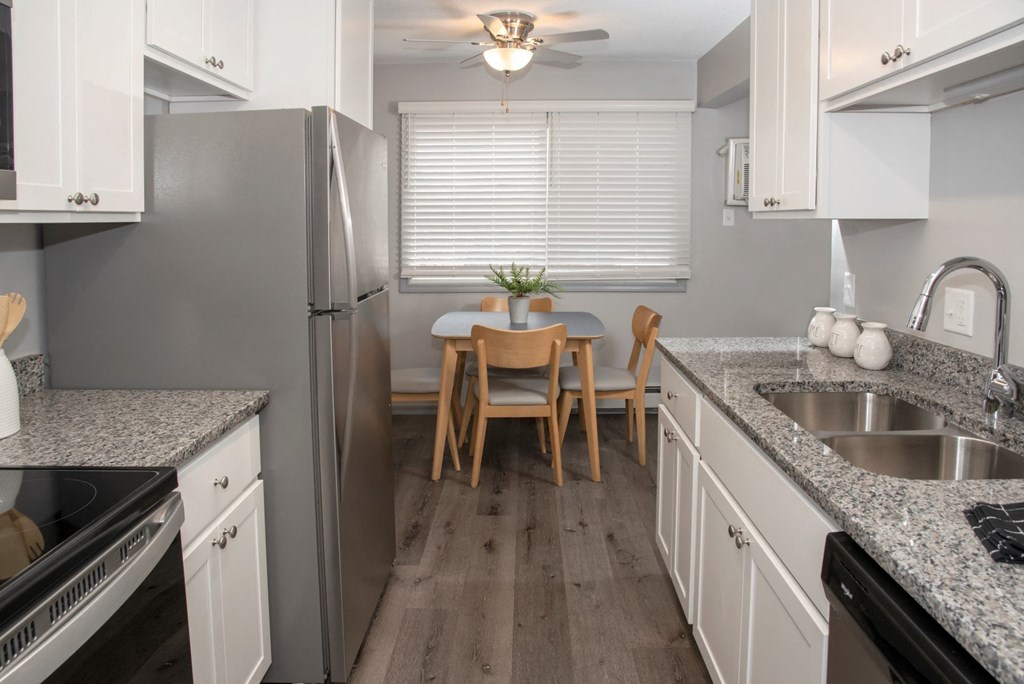 galley style kitchen with new finishes and dining area