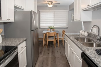 galley style kitchen with new finishes and dining area - Photo Gallery 4