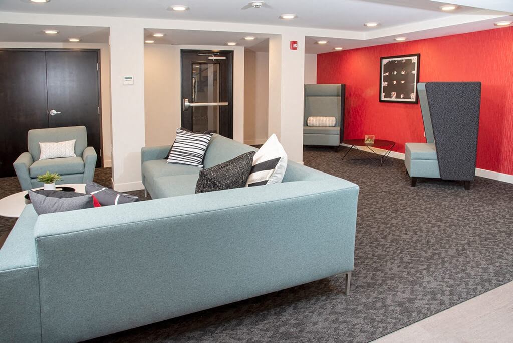 Community room  With couch and chairs at Eagan Place Apartments in Eagan, MN