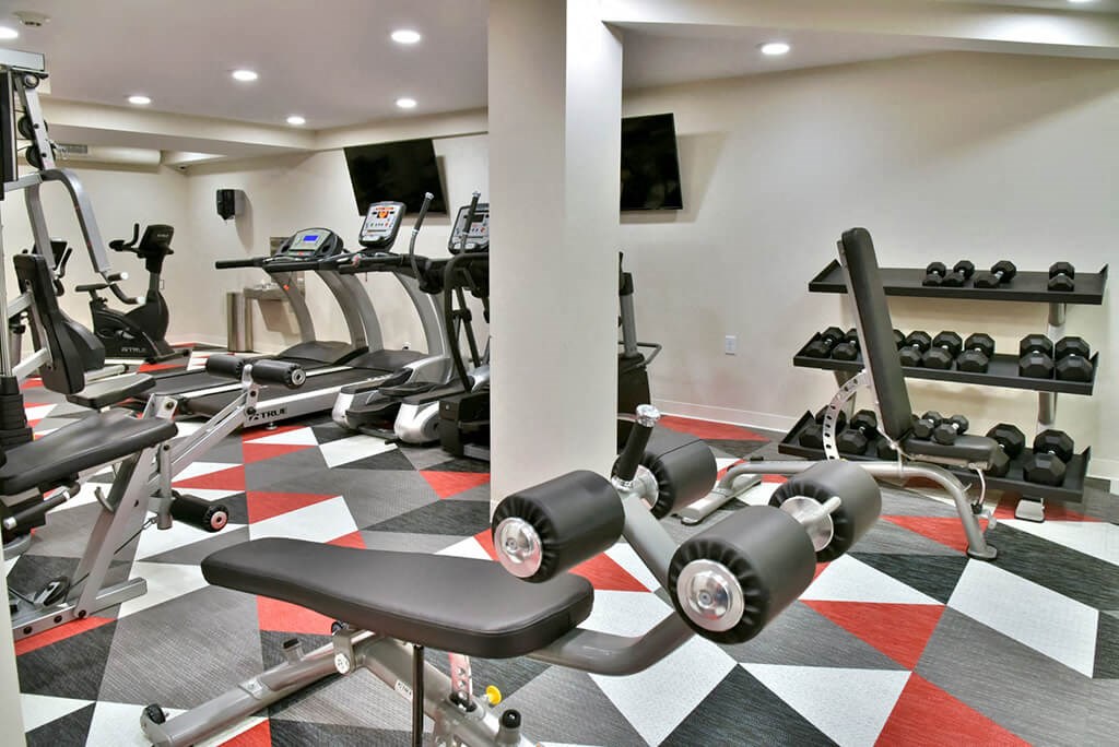 fitness room with weights and cardio machines