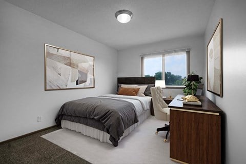 a bedroom with a bed and desk in a 555 waverly unit