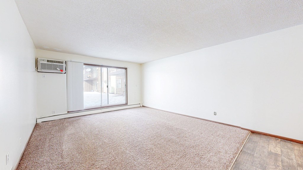 a bedroom with a sliding glass door and a carpeted floor