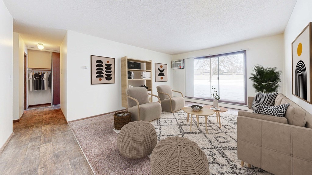 a living room with white walls and a large window