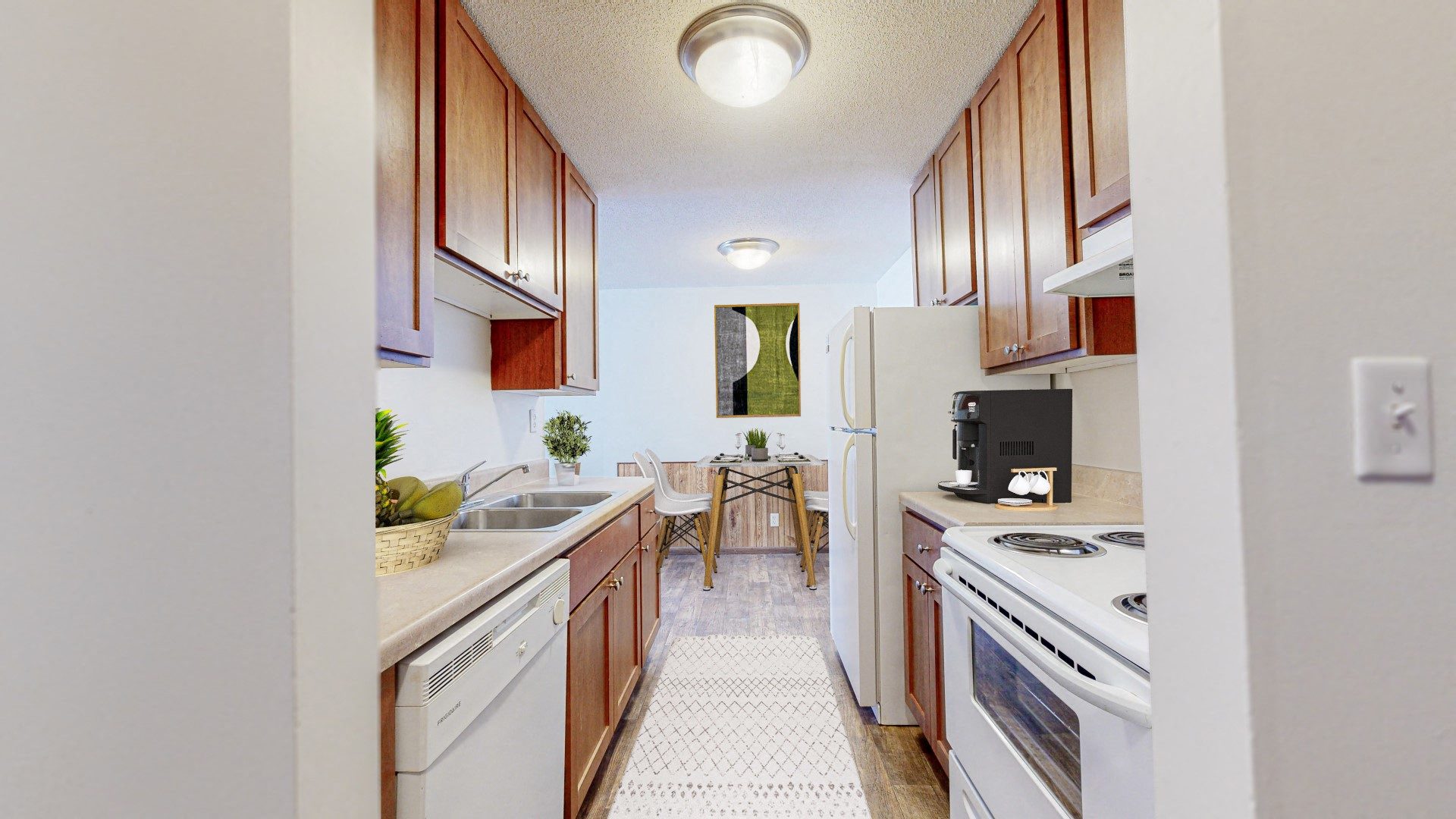 a kitchen with white appliances and wooden cabinets