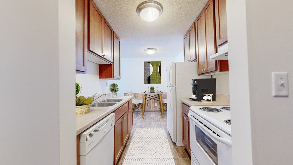 a kitchen with white appliances and wooden cabinets