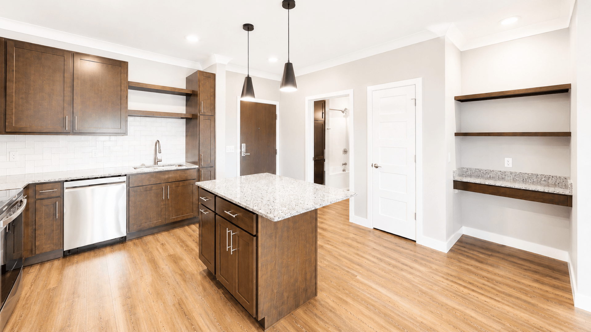 A kitchen with wooden cabinets and a white countertop.