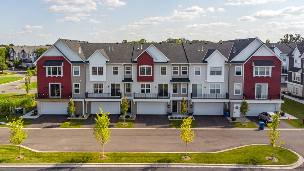 an aerial view of a row of townhouses in a street