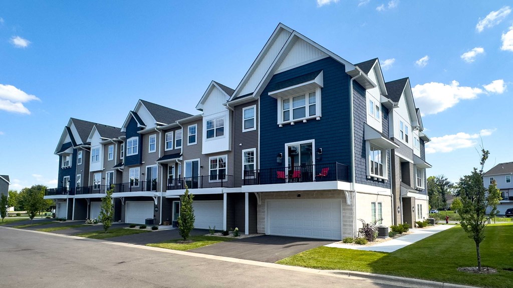 a row of blue and white townhomes on a street