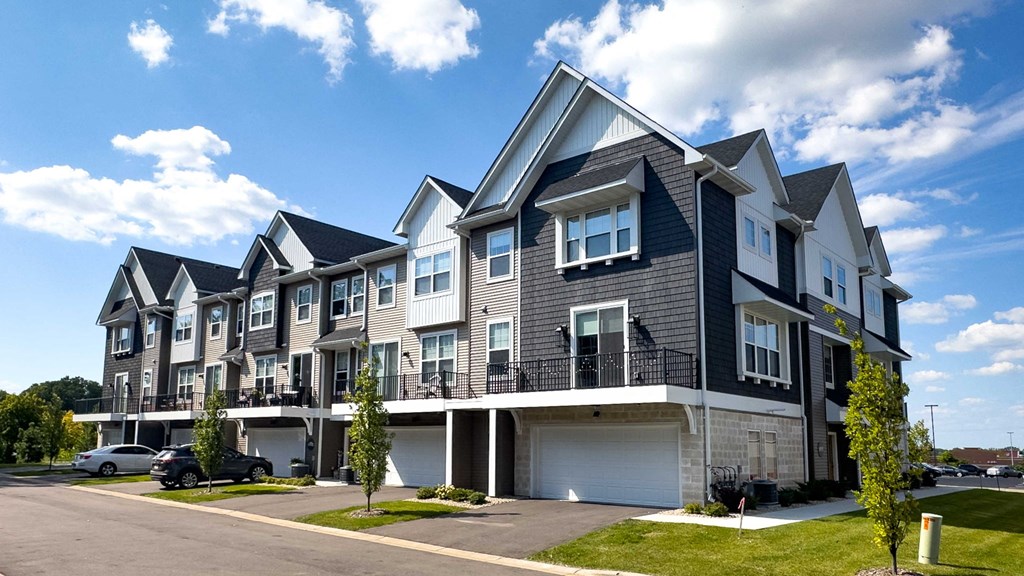 a row of town houses with balconies and a street