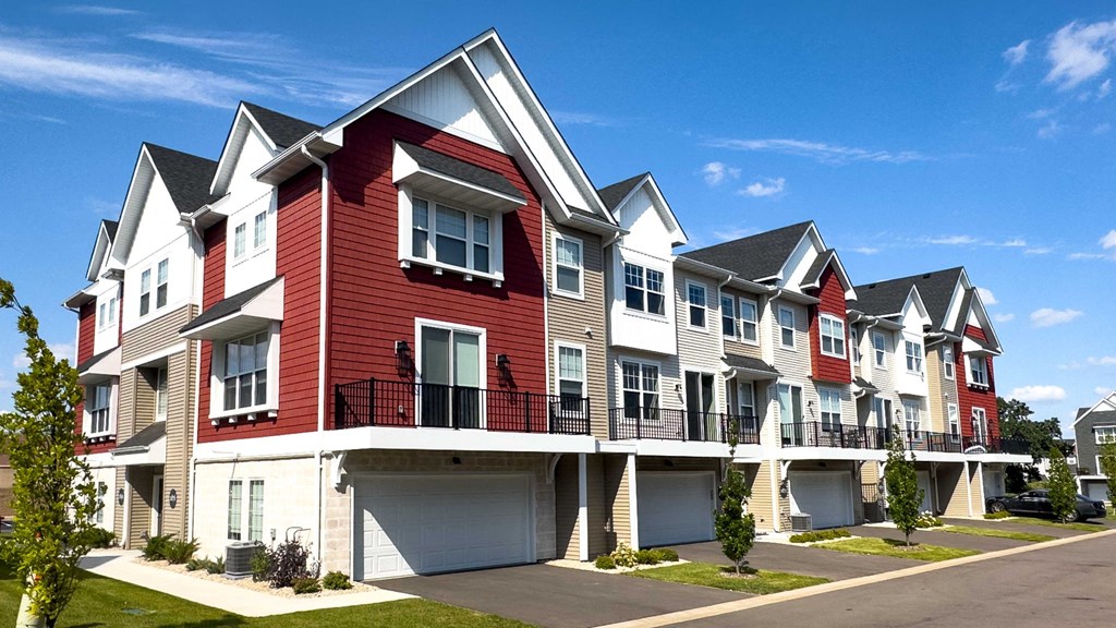 a row of town houses with red and white exterior