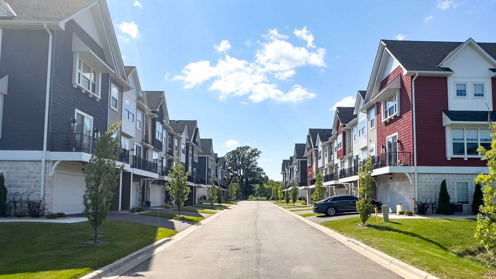 a row of townhomes on the side of a street