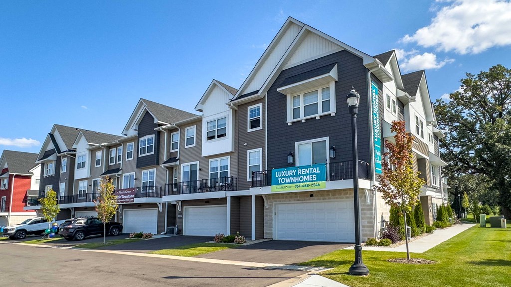a townhome community with a street sign in front of it