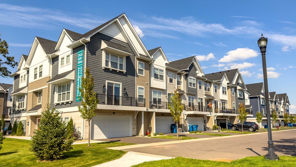 a row of town houses with balconies and street lights