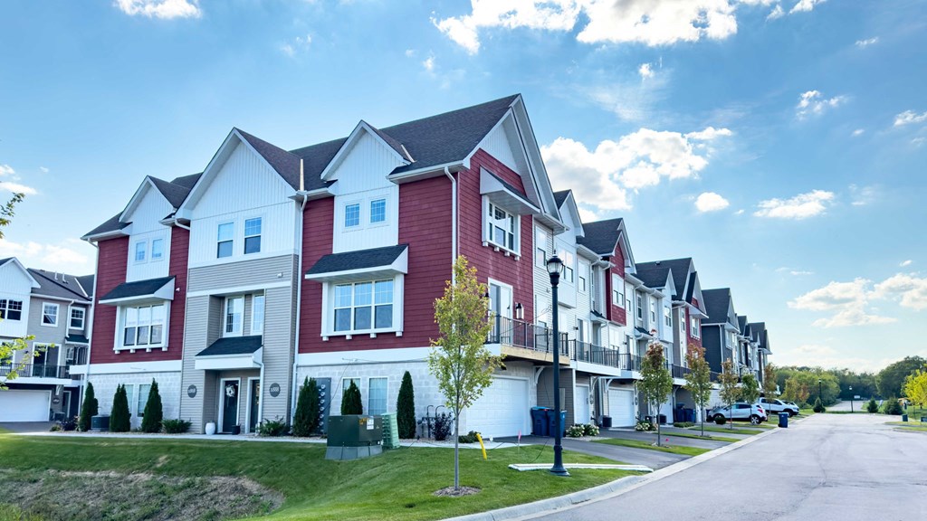a row of red and white houses on a street