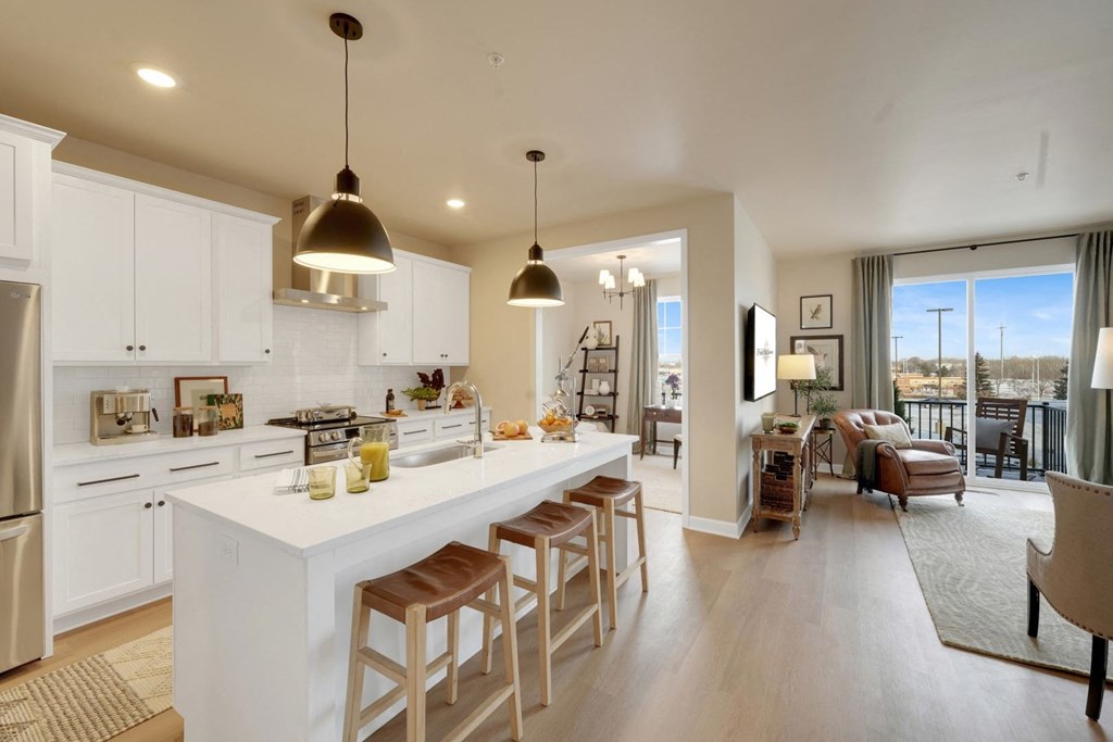 a kitchen and living room with a white counter top