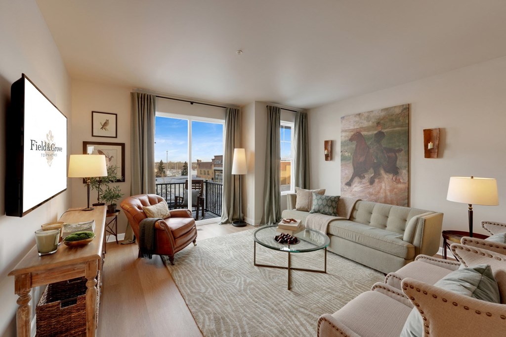 a living room filled with furniture and a large window