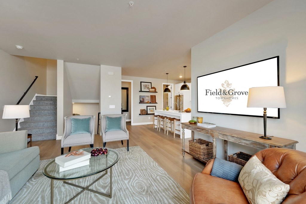 a living room with a couch and a tv on the wall