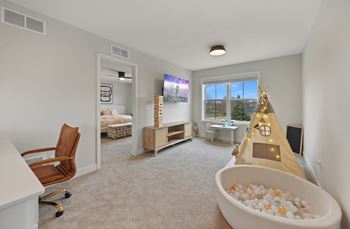 a play room with a christmas tree and a bath tub