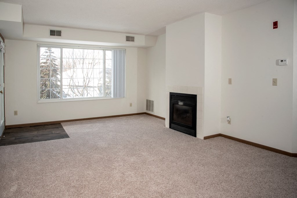 Living room with fireplace in select homes