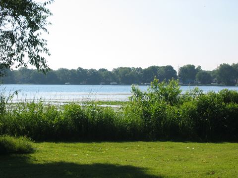 a view of the water from a grassy field