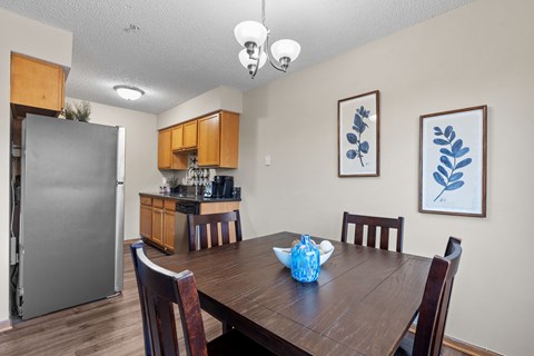 A dining room with a wooden table and chairs.