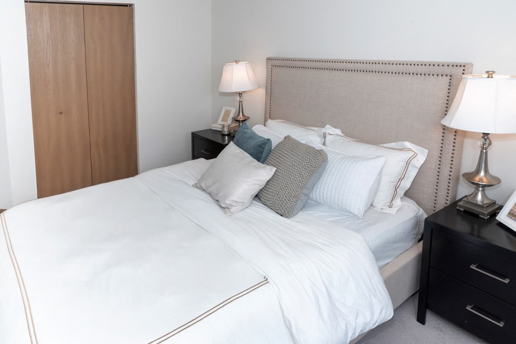 a bedroom with a bed and two nightstands