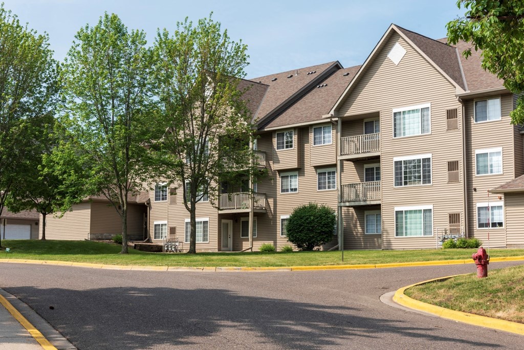 a large apartment building with a fire hydrant in front of it