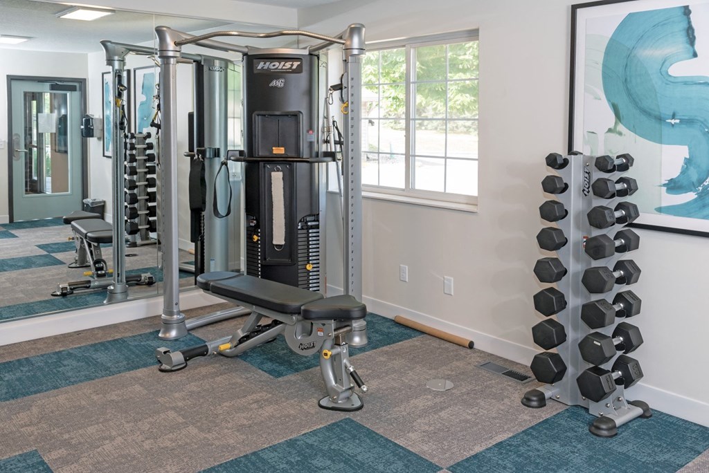 a home gym with a large mirror and exercise equipment