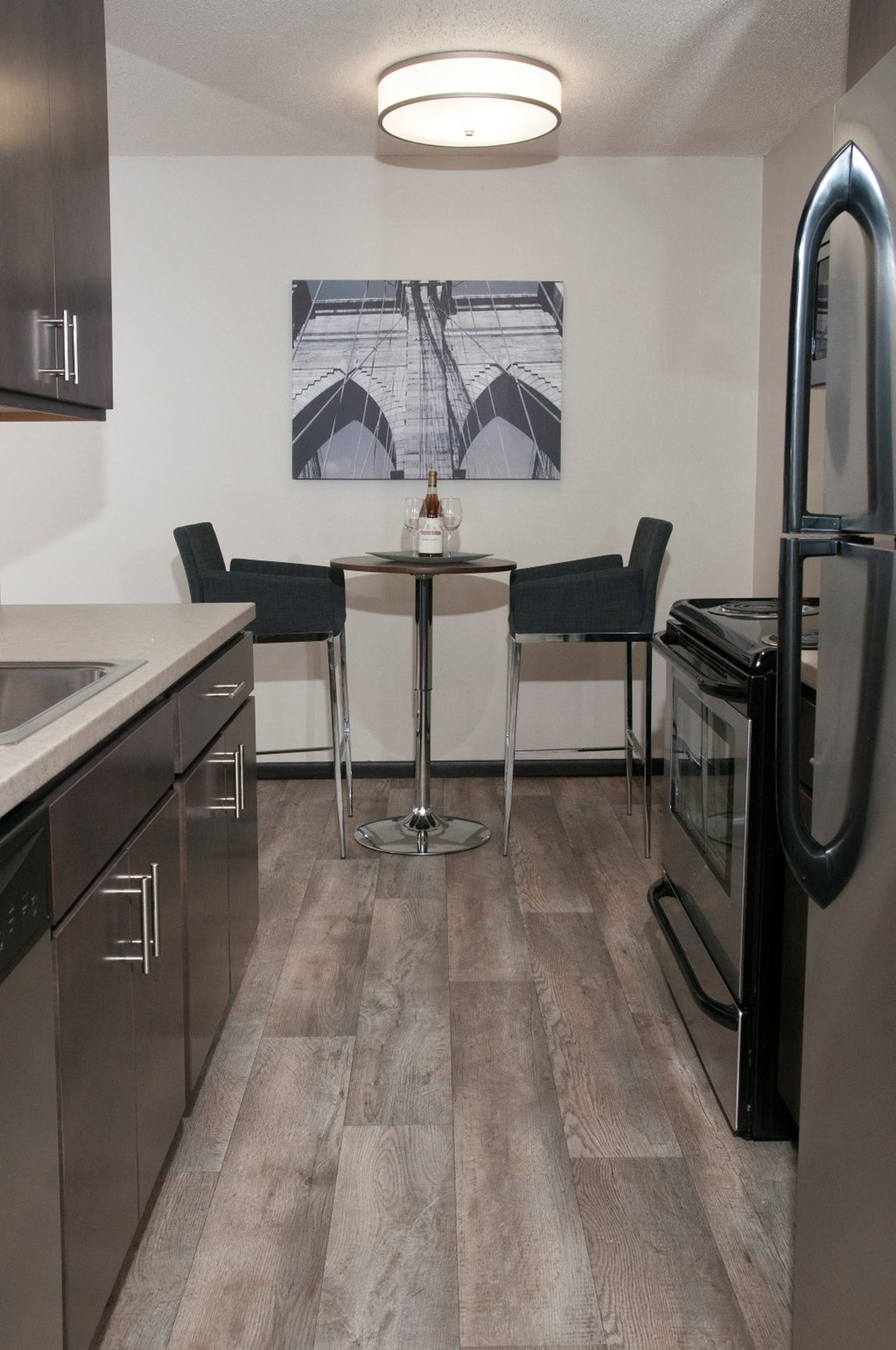 a kitchen with stainless steel appliances and a table and chairs